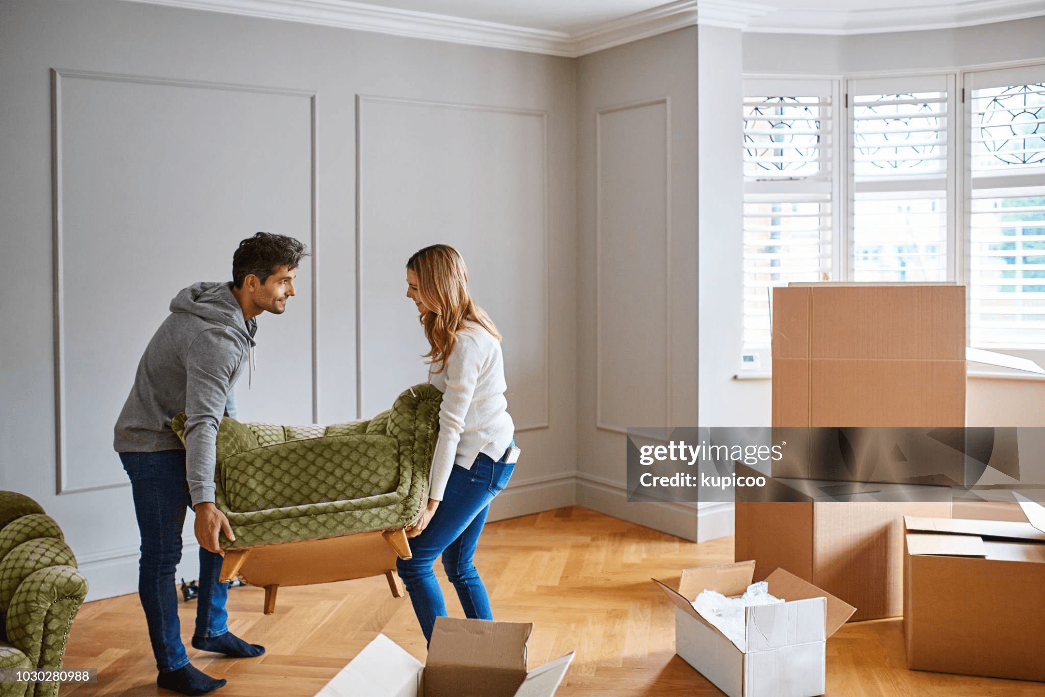 People moving furniture into a home